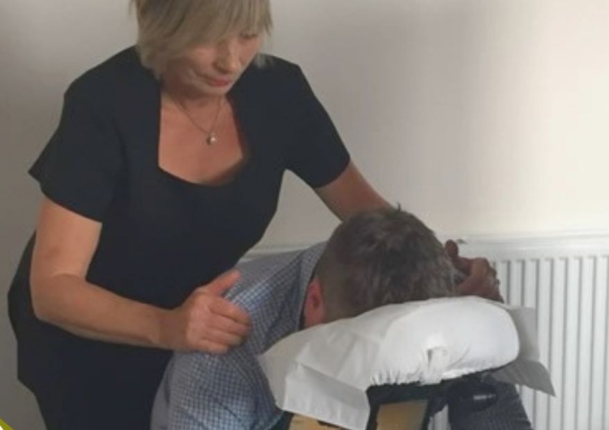 Seated chair massage focused on the back, neck and shoulders