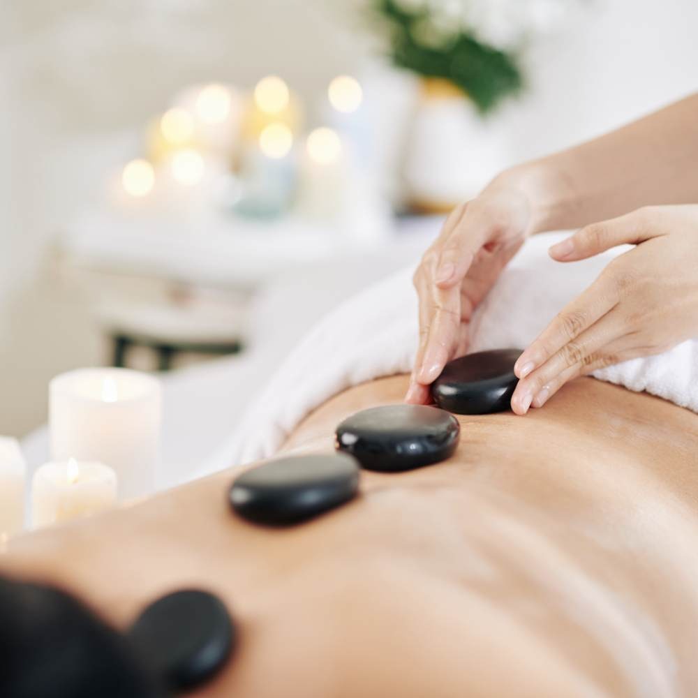 Heated stones arranged for a hot stone massage treatment